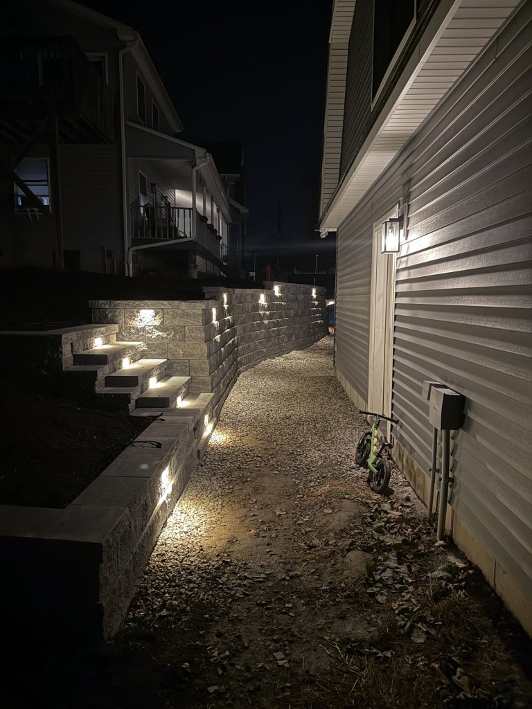 Landscape lighting illuminating stone steps in the evening