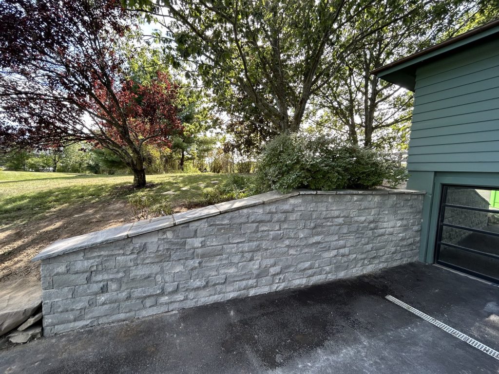 Stone retaining wall with Japanese maple landscape design