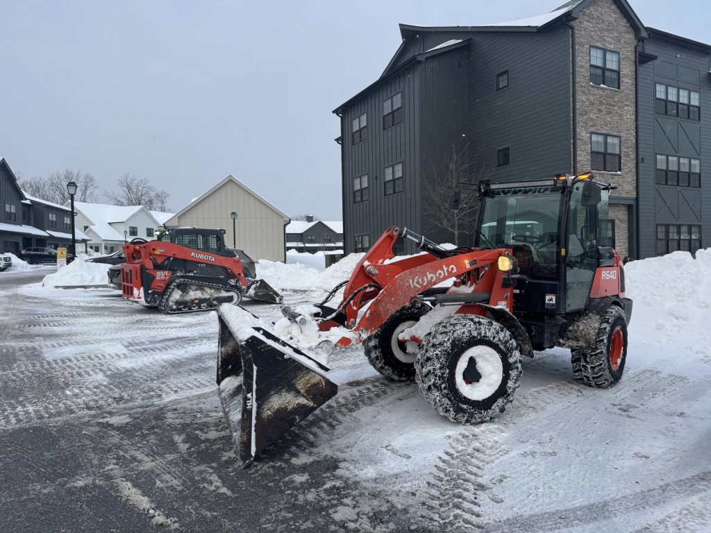 Dutchess Lawns & Masonry snow removal truck and skid-steer at a commercial property