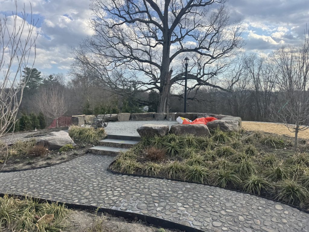 Hardscape walkway with stone wall and landscape lighting
